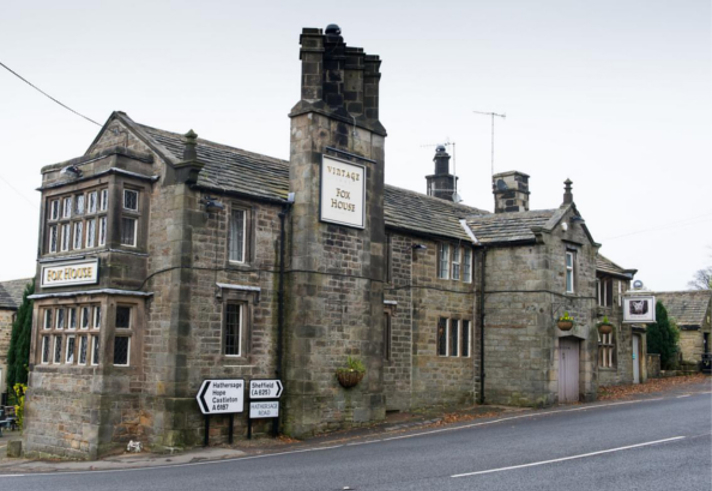 The exterior of The Fox House, a stone building with an impressive chimney stack.