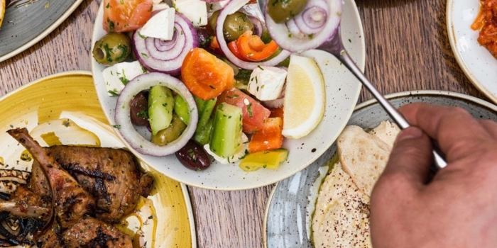 Plates of fresh Turkish food laid out on a table.