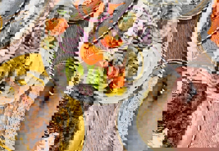 Plates of fresh Turkish food laid out on a table.