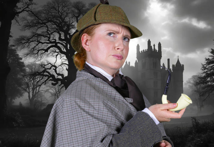 A woman dressed as Sherlock Holmes, holding a curved pipe, looks quizzical. 