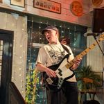 A person playing guitar on stage.
