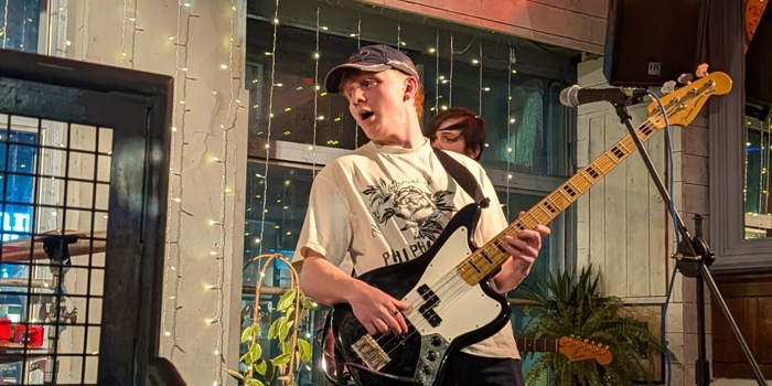 A person playing guitar on stage.