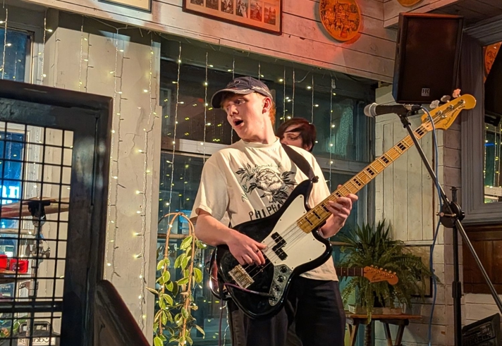 A person playing guitar on stage.
