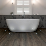 Spacious bathroom featuring a freestanding bathtub and modern fixtures.