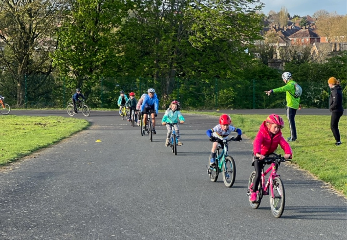 A group of children taking part in an outdoor cycling activity.