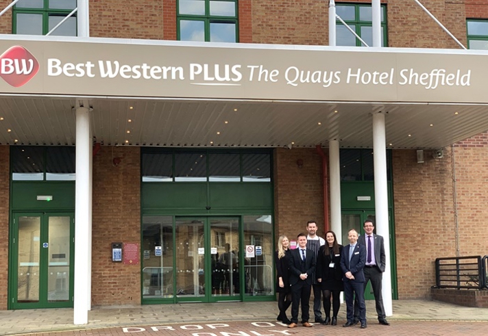 Members of staff  pose for a photo outside the entrance to The Quays Hotel.