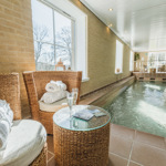 Indoor spa area at Losehill Hall Hotel featuring a swimming pool and relaxing seating.