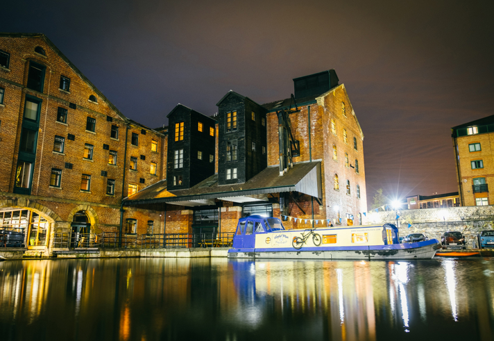 Victoria Quays lit up at night.