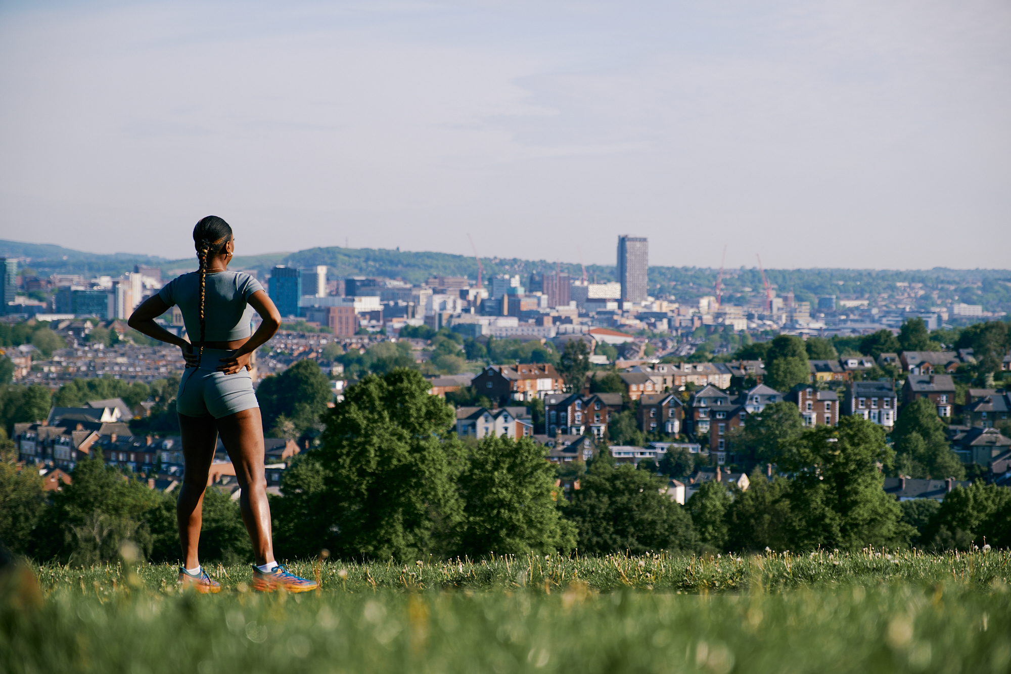 A runner takes in the cityscape view at Meersbrook Park 