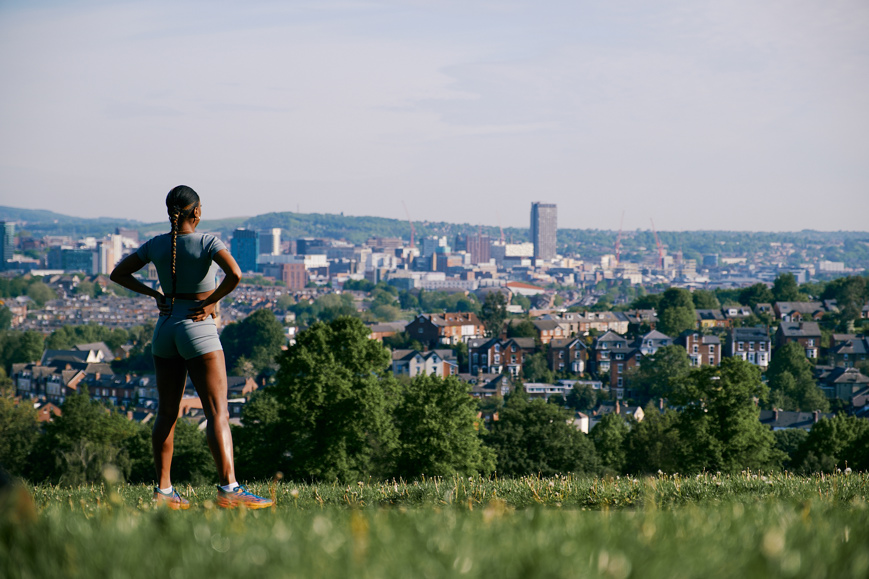 A runner looking out towards the city from Meersbrook park