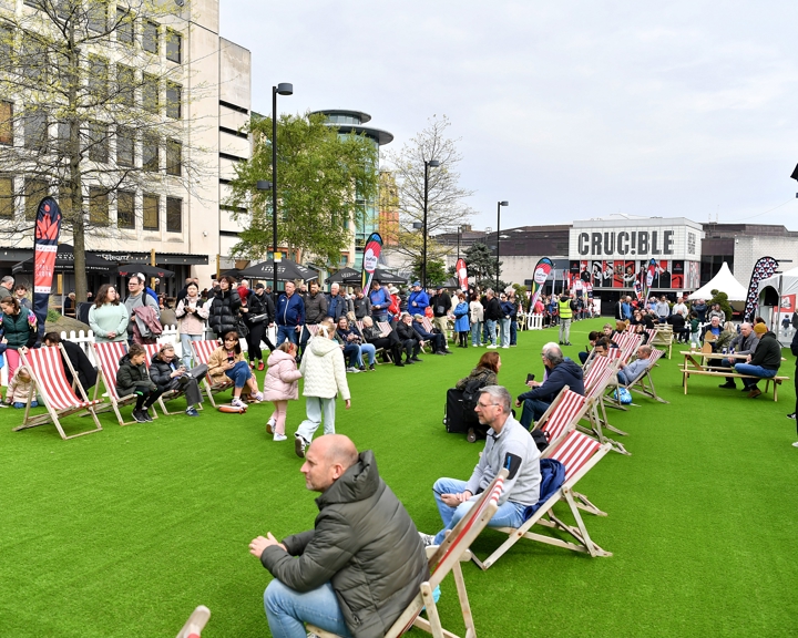Tudor Square, in Sheffield city centre, is thronging with people, who have come to watch the snooker at The Crucible. Some people are sat on deck chairs watching the matches on a big screen.