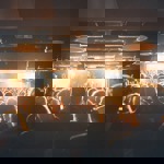 A crowd of people watching a band playing live.