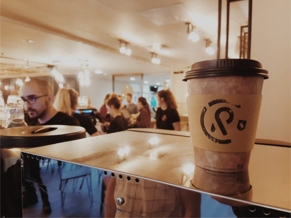 The interior of Coffee Revolution, featuring one of their disposable coffee cups.
