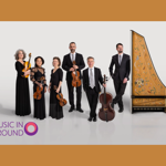 A group of musicians, in smart evening wear, pose with their instruments including a harpsicord standing on its end.
