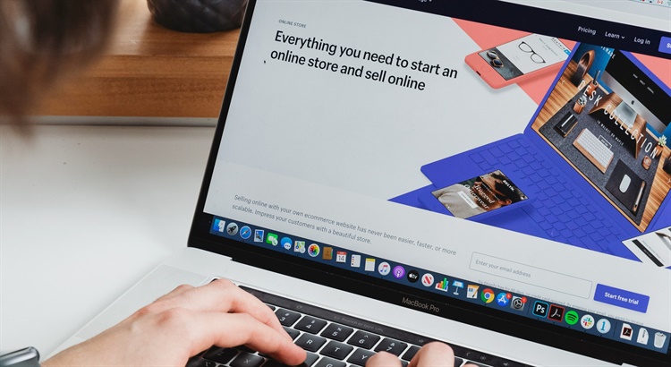 Stock image of a person typing on a laptop.