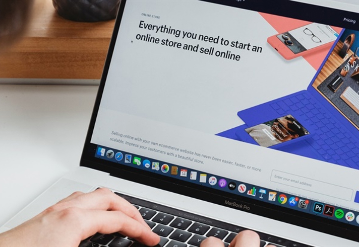 Stock image of a person typing on a laptop.