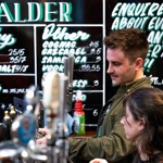 Two people working behind the bar at Alder.