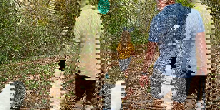 A family, in the woods, on an Easter Egg Hunt.