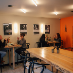 Interior of Bench with people sat at tables.