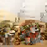 A wicker chair, with a coffee on a small side table, at the Dana Cafe.