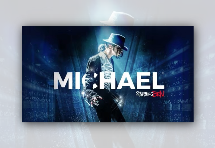 Promotional graphic for MICHAEL Starring BEN. A performer in a black jacket, white shirt and black fedora stands in profile under bright blue stage lighting. Large white text reading “MICHAEL” spans the centre of the image, with “Starring BEN” in smaller white and red text beneath. The background shows a theatre auditorium and audience faded into a blue, spotlight-filled scene.