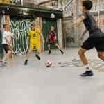 Four boys play indoor football at Yard Ball.