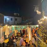 Customers in the outdoor seating are at Piña, at night.