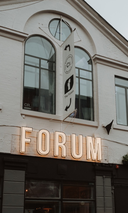 The Forum Kitchen + Bar sign on the outside of the building.