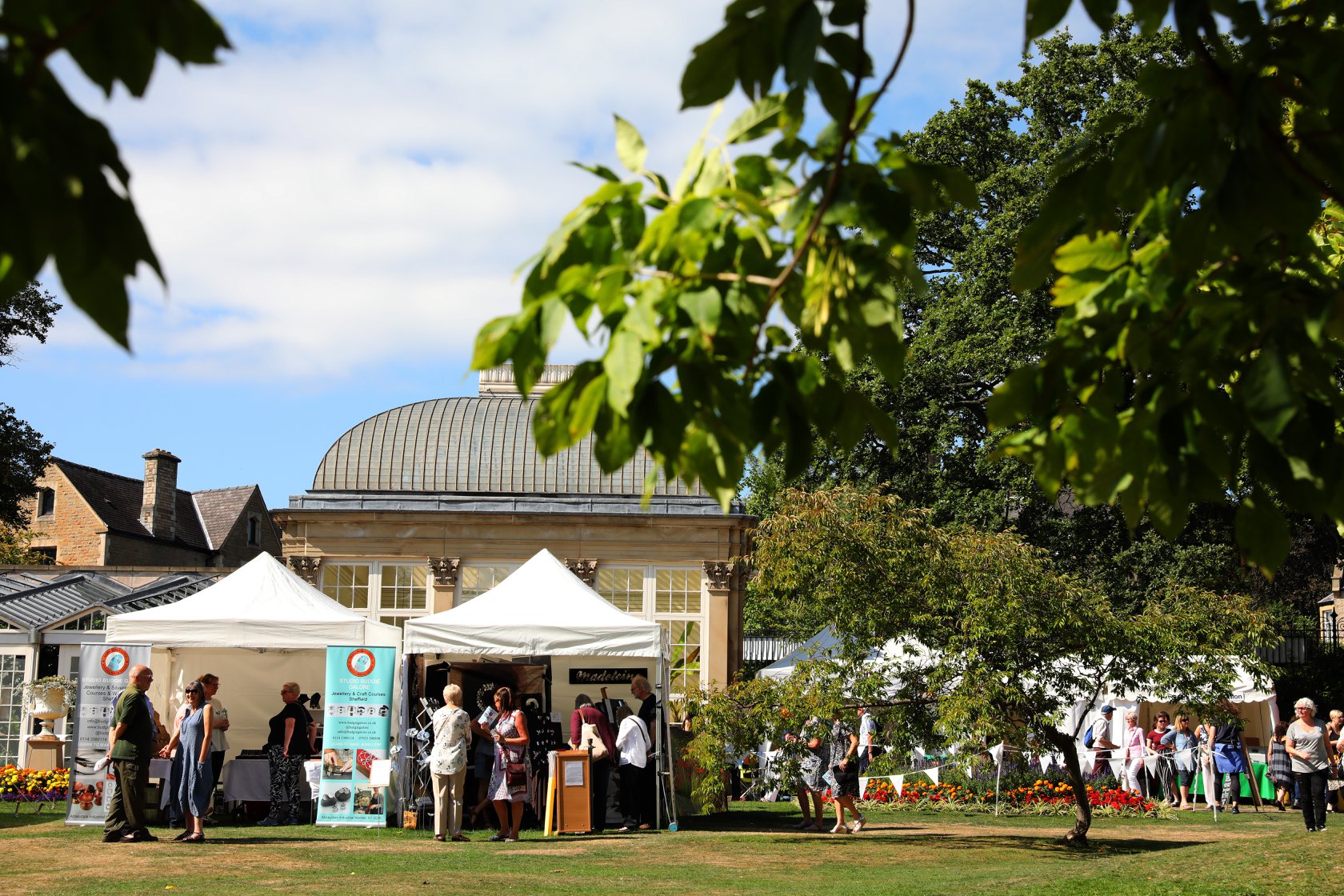 Tents set up in the grounds of Sheffield Botanical Gardens.