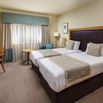 Mercure Sheffield Parkway Hotel twin room with two cosy beds and bright interior.