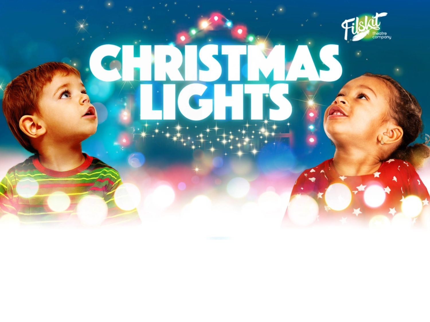 Two small children are looking in wonder at Christmas lights.