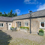 Exterior of Gooseberry Farm Cottages showing traditional stone buildings
