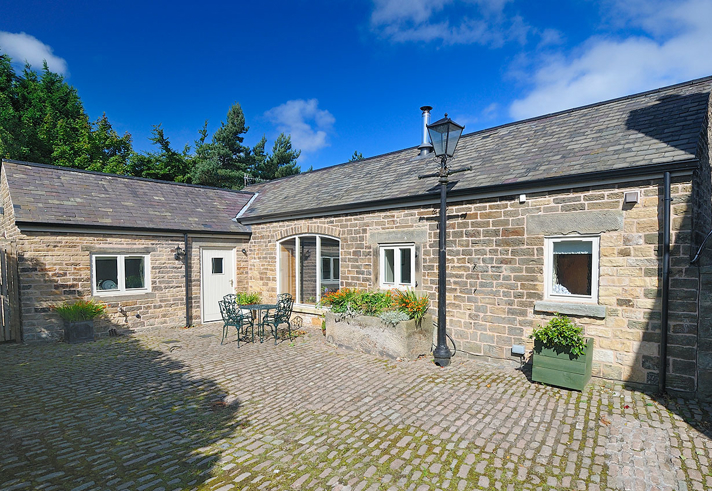 Exterior of Gooseberry Farm Cottages showing traditional stone buildings