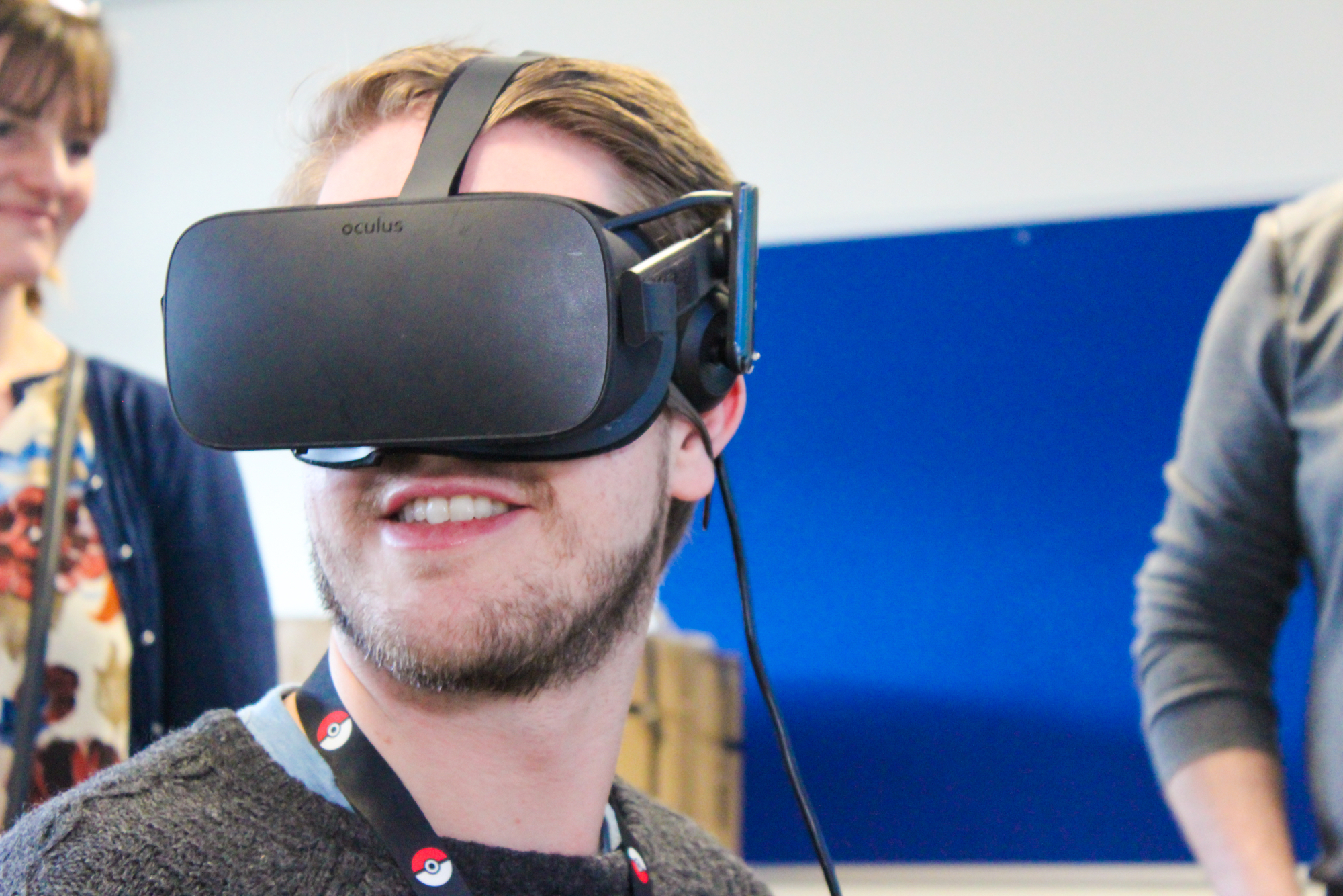 A smiling bearded man wearing a virtual-reality headset.
