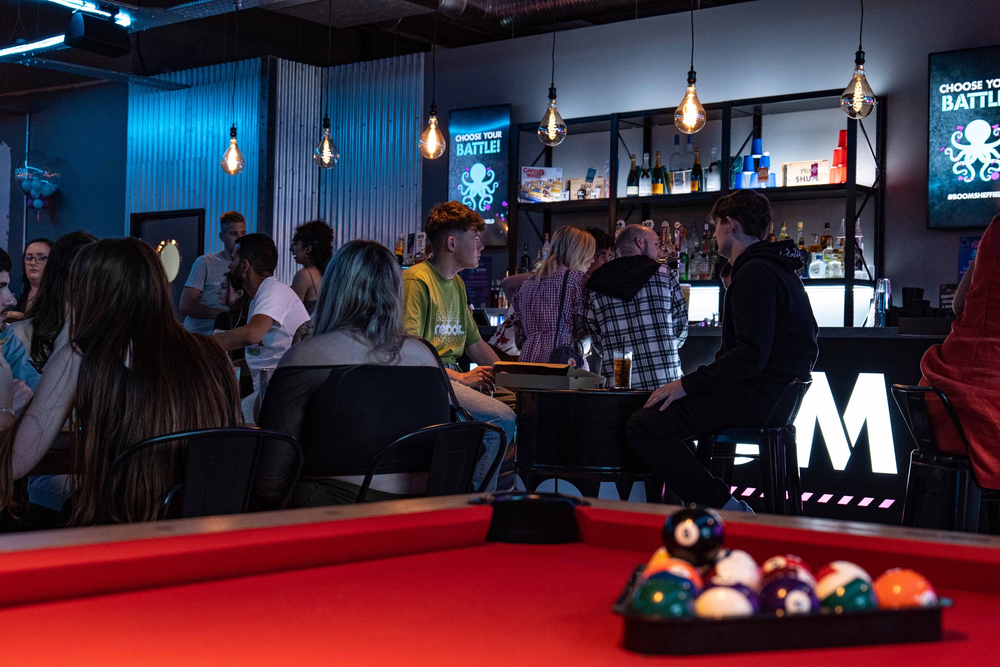 Pool table with the balls racked up at Boom Battle Bar.