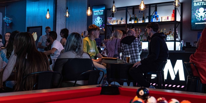 Pool table with the balls racked up at Boom Battle Bar.