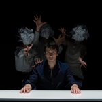 Four people performing a dance on stage.