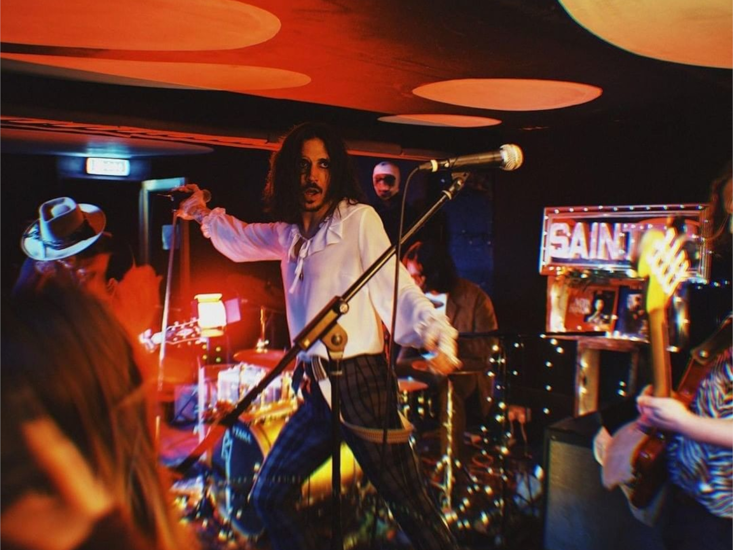 A band plays live at a small venue.