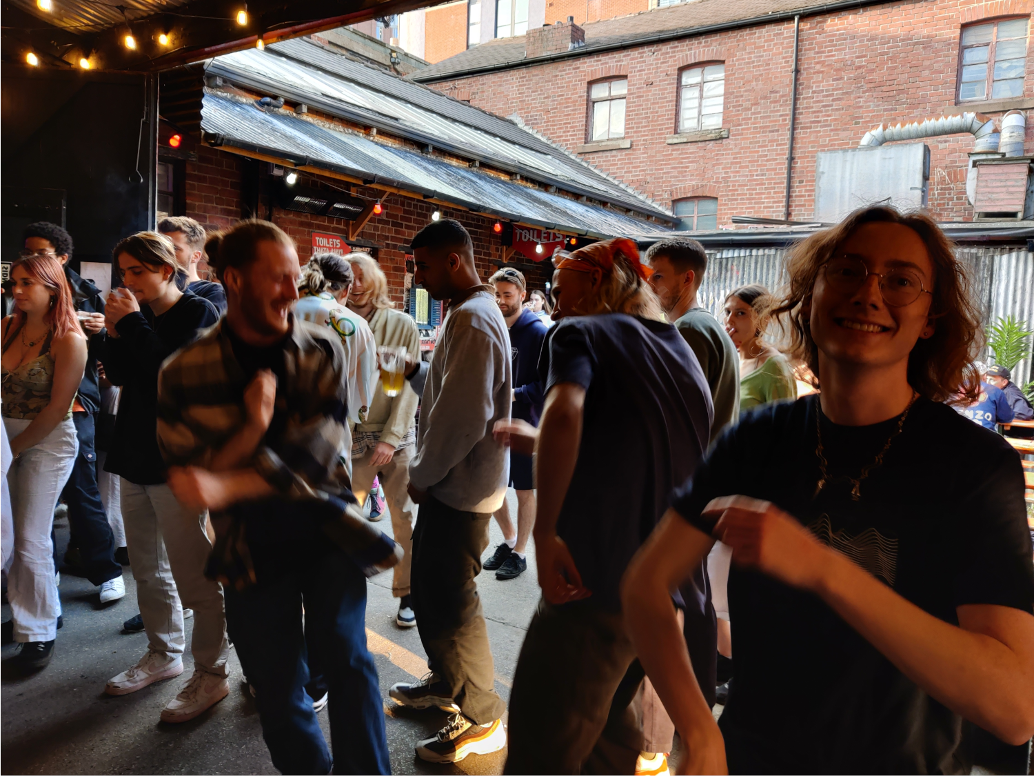 A group of people dancing at a night out.