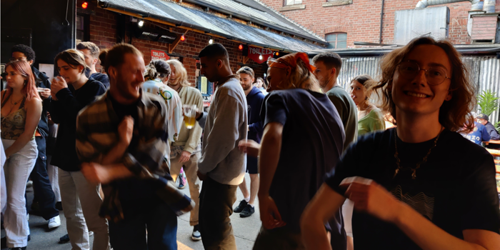A group of people dancing at a night out.