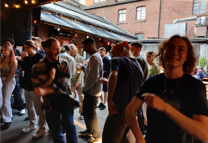 A group of people dancing at a night out.