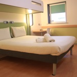 Bedroom with a double bed and a bunk bed above.