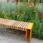 Garden bench surrounded by lush green plants.