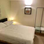 Bright and tidy small double bedroom in Homely Apartments – Figtree with modern décor
