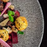 Food on a grey speckled plate.