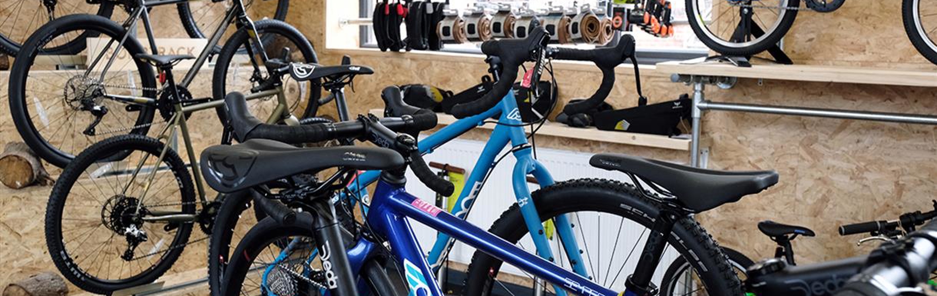 The interior of a shop filled with bikes and cycling equipment on display.
