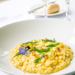 A plate of food and a glass of wine.