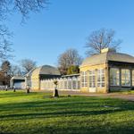 The Sheffield Botanical Gardens glass house on a sunny day.