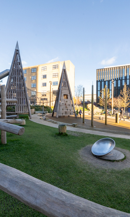 A view across Pound's Park, showing the play equipment and beches.