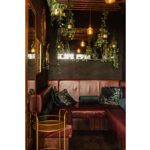 A booth with leather seats and subdued lighting at The Gin Bar.